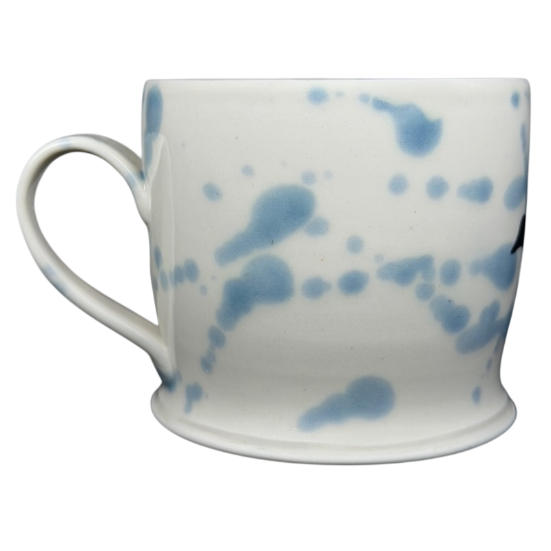 Narwhal signed pottery mug featuring a unique blue splatter design on a white background