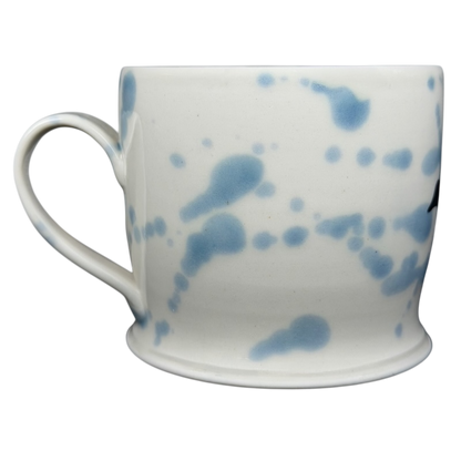 Narwhal signed pottery mug featuring a unique blue splatter design on a white background