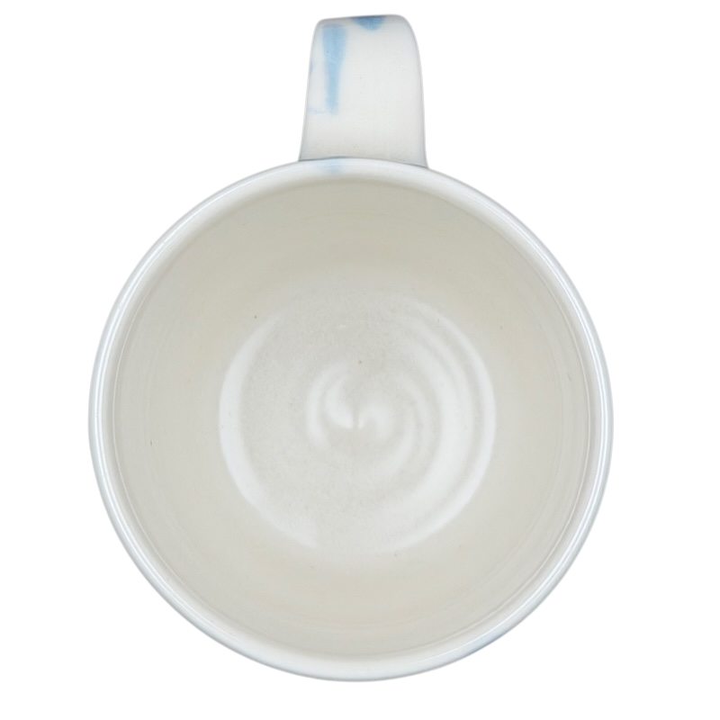 Inside view of a narwhal signed pottery mug showcasing smooth ceramic finish