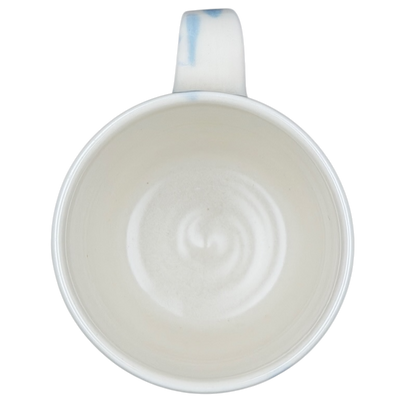 Inside view of a narwhal signed pottery mug showcasing smooth ceramic finish