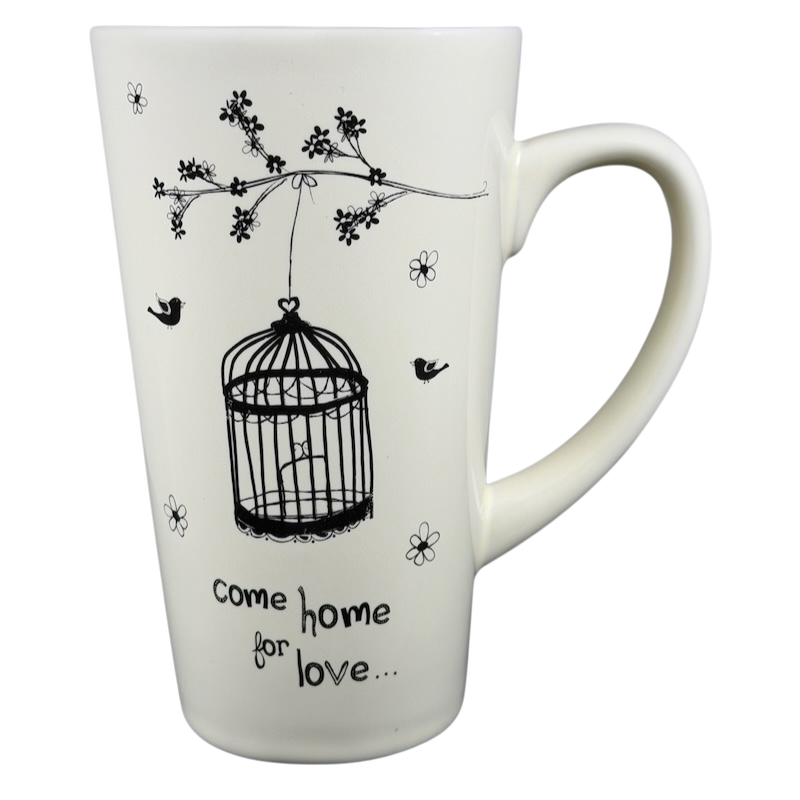 Natural Life Come Home For Love mug featuring a birdcage design and floral accents