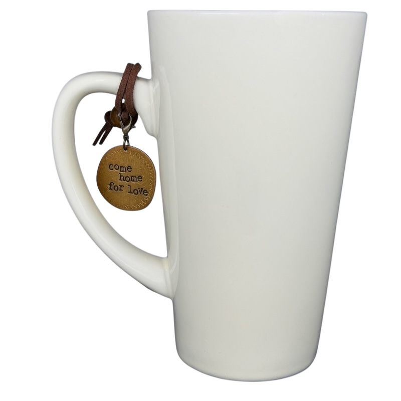 Natural Life Come Home For Love mug with a charm hanging from the handle and a minimalist design