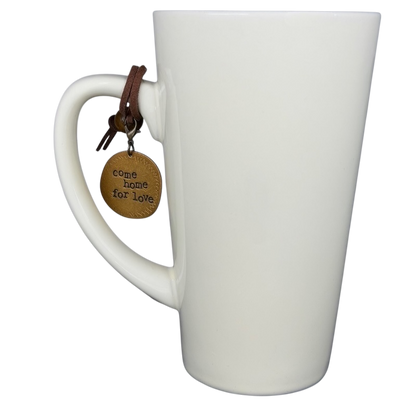 Natural Life Come Home For Love mug with a charm hanging from the handle and a minimalist design