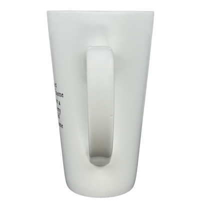 Back view of tall white ceramic perfect world Natural Life cat mug with large handle and partial printed phrase