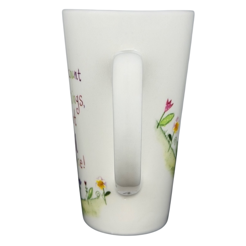 Natural Life When I Count My Blessings mug with colorful floral designs and inspirational text