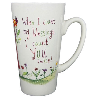 Natural Life When I Count My Blessings mug featuring colorful flowers and an uplifting message