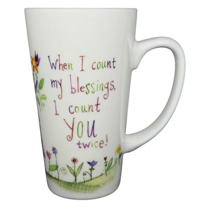 Natural Life When I Count My Blessings mug with colorful floral design and inspirational text