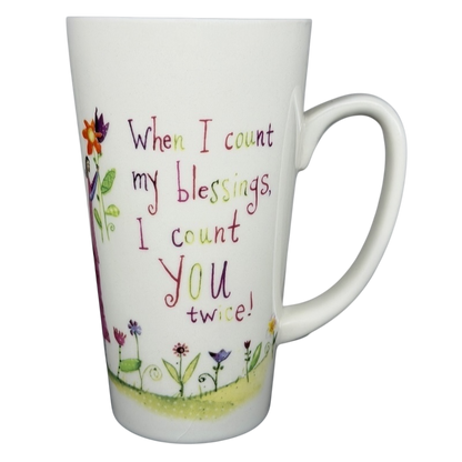 Natural Life When I Count My Blessings mug featuring colorful floral design and inspiring quote