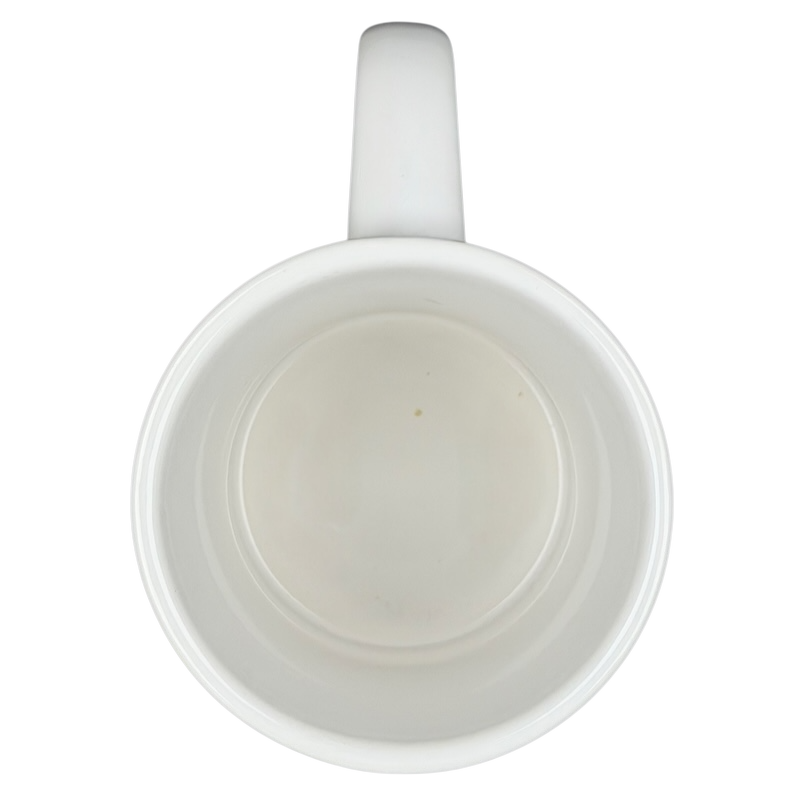 Inside view of a white mug featuring New Orleans skyline piano notes design