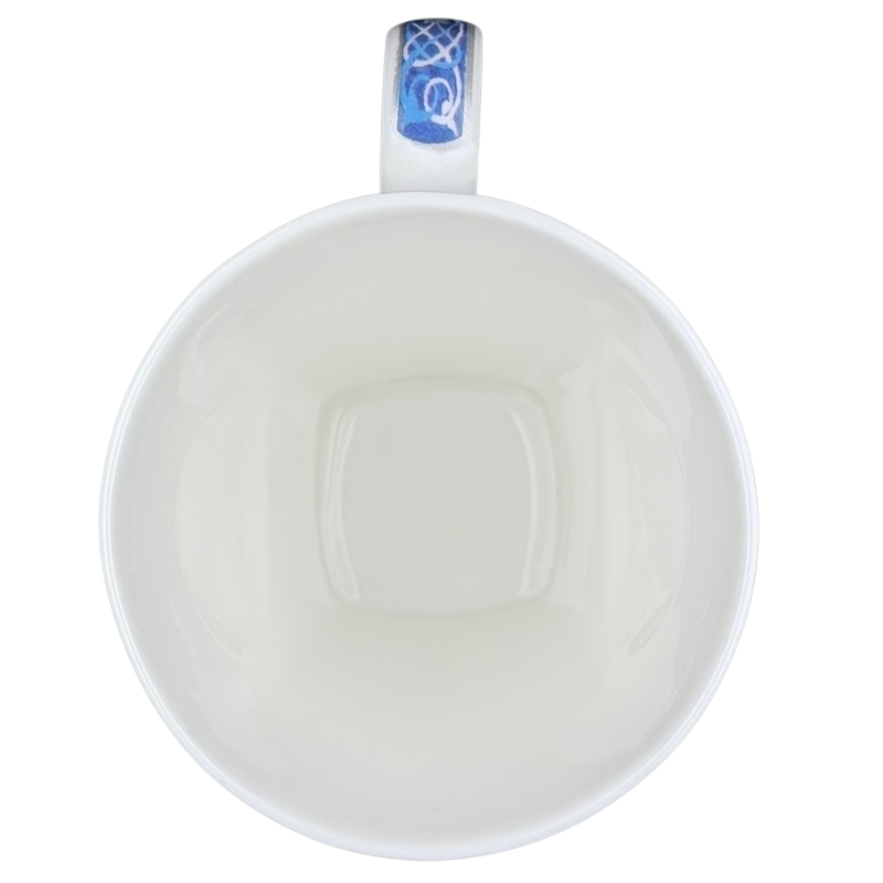 Inside view of a Celtic mug Past Times collectible with a smooth white finish and decorative blue handle