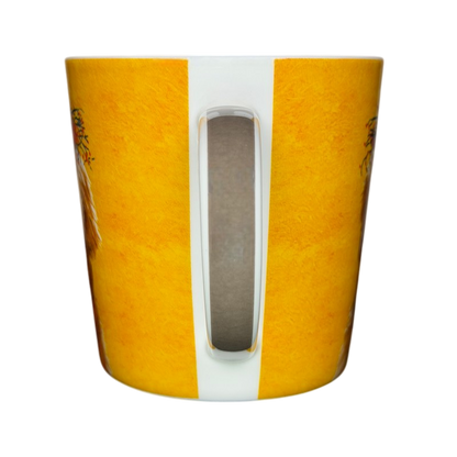 Patti Gay Glacier Dudley Goldendoodle Mug Two Can Art PPD with vibrant yellow background and dog illustrations