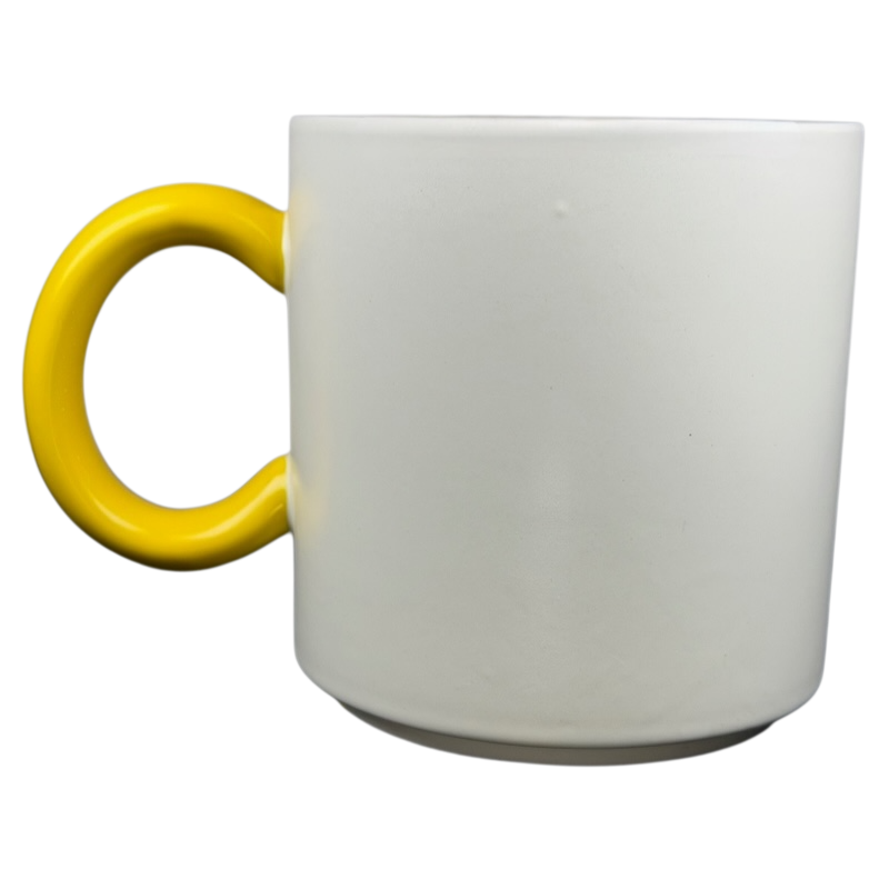 White Hallmark mug featuring a yellow handle, inspired by Peanuts Movie Charlie Brown Snoopy