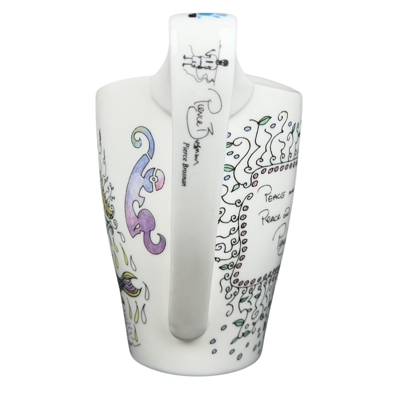 Pierce Brosnan Whatever It Takes mug featuring colorful designs and signature details
