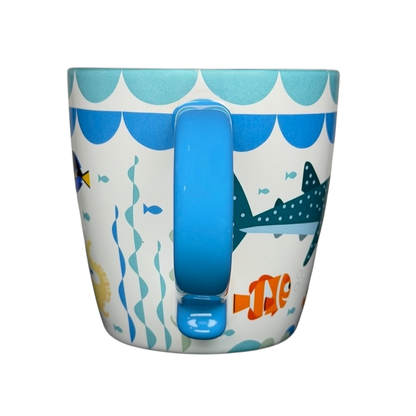 Finding Dory Mug Pixar Disney Store featuring colorful ocean graphics and a blue handle