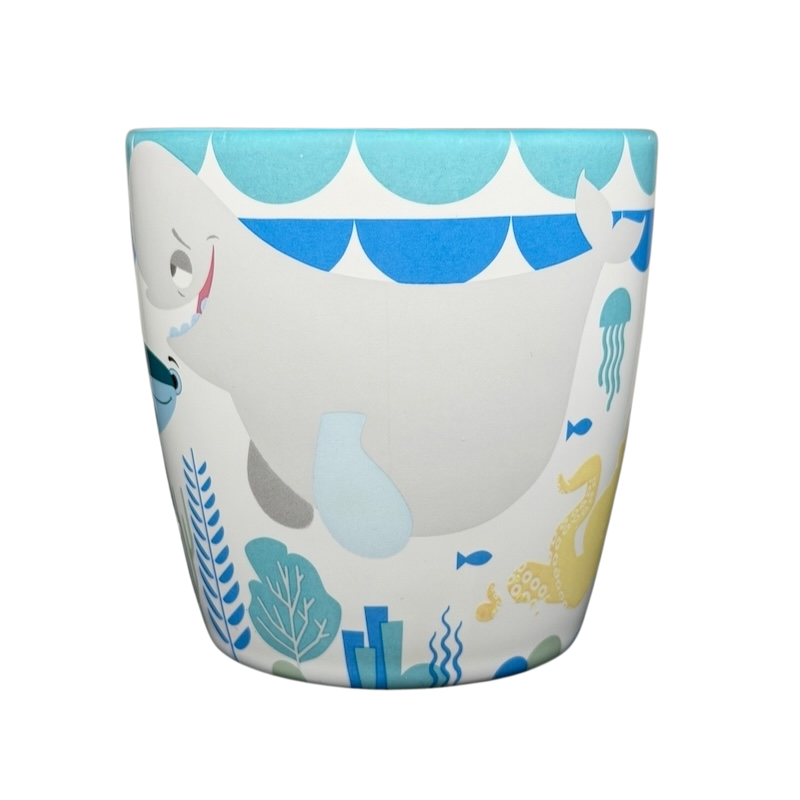 Finding Dory Mug Pixar Disney Store featuring colorful marine life and a playful whale design