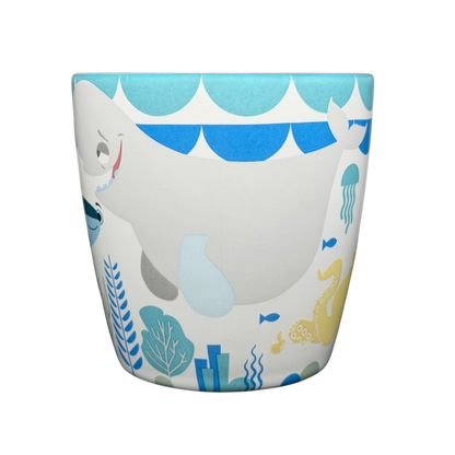 Finding Dory Mug Pixar Disney Store featuring colorful marine life and a playful whale design
