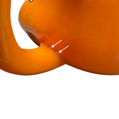 Close-up of the handle on a Pokemon Charmander Mug featuring vibrant orange color and playful design