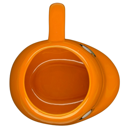 Top view of a bright orange Pokemon Charmander Mug featuring a cute design