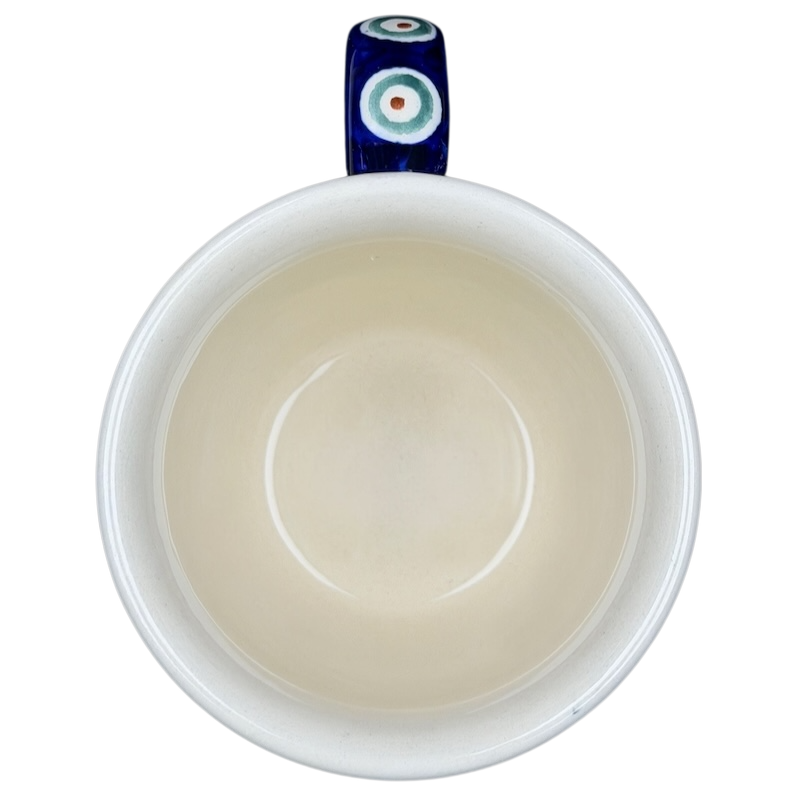 Polish pottery blue peacock eye mug with intricate design and a vibrant handle