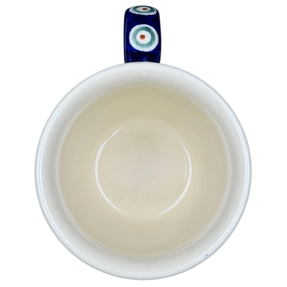 Polish pottery blue peacock eye mug with intricate design and a vibrant handle