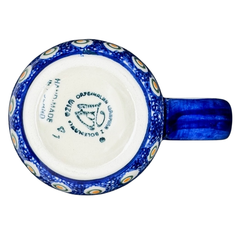 Polish Pottery Red Floral and Peacock Eye Boleslawiec mug with intricate blue and white design on the exterior