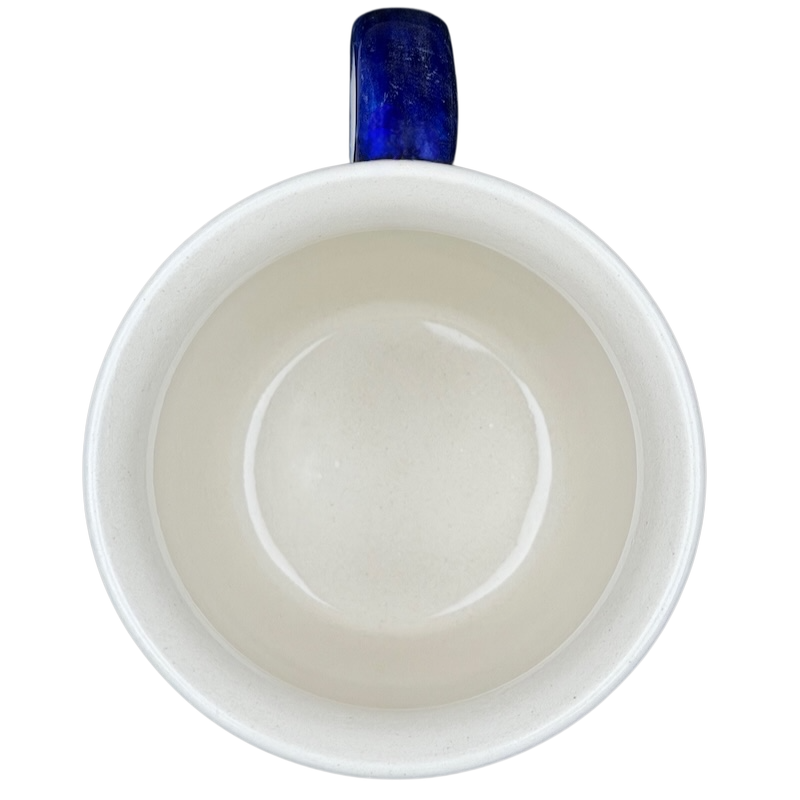 Interior view of Polish Pottery Star Spangled Mug showcasing smooth ceramic finish and blue handle