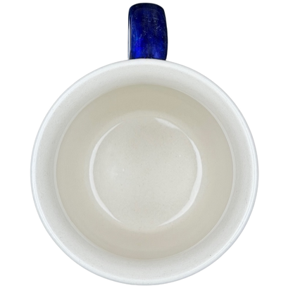 Interior view of Polish Pottery Star Spangled Mug showcasing smooth ceramic finish and blue handle