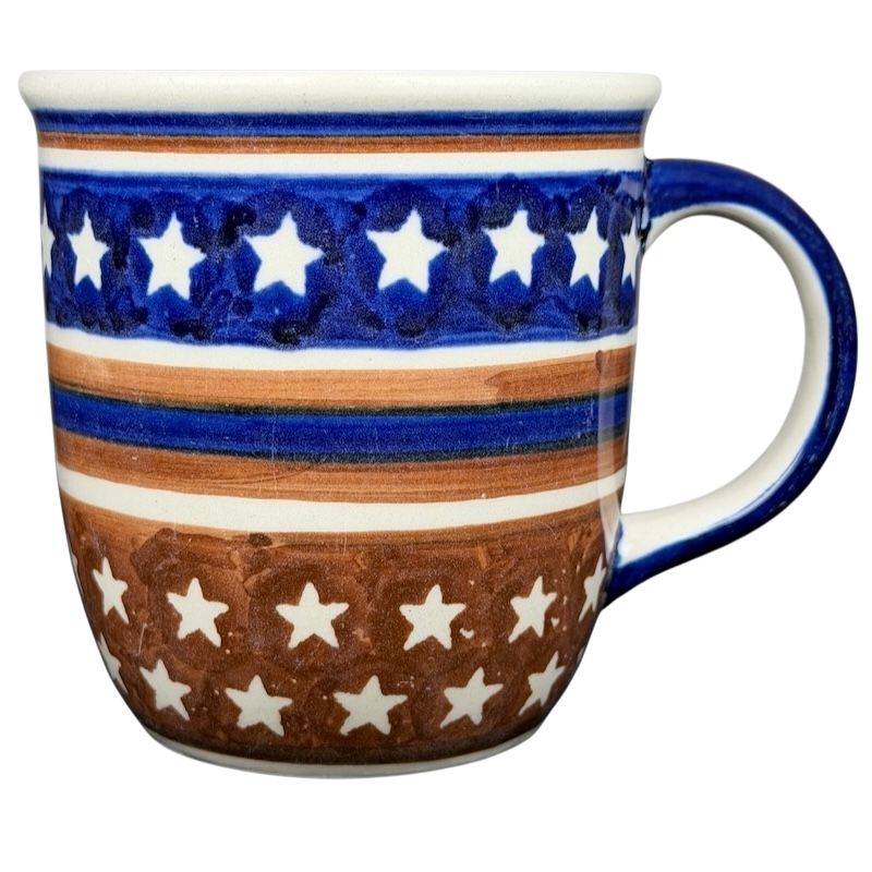 Polish Pottery Star Spangled Mug featuring a vibrant blue and brown star design for festive occasions