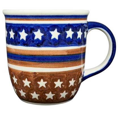 Polish Pottery Star Spangled Mug featuring a vibrant blue and brown star design for festive occasions