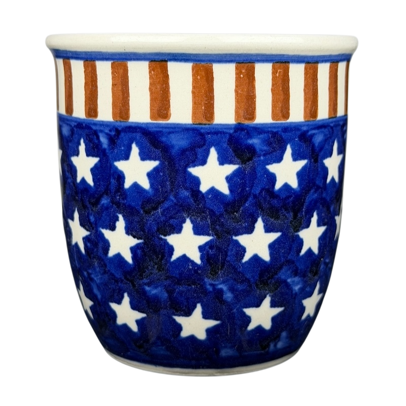 Polish pottery stars and stripes mug featuring a blue background with white stars and orange stripes