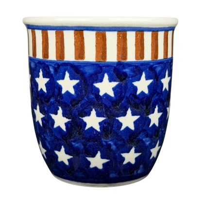 Polish pottery stars and stripes mug featuring a blue background with white stars and orange stripes