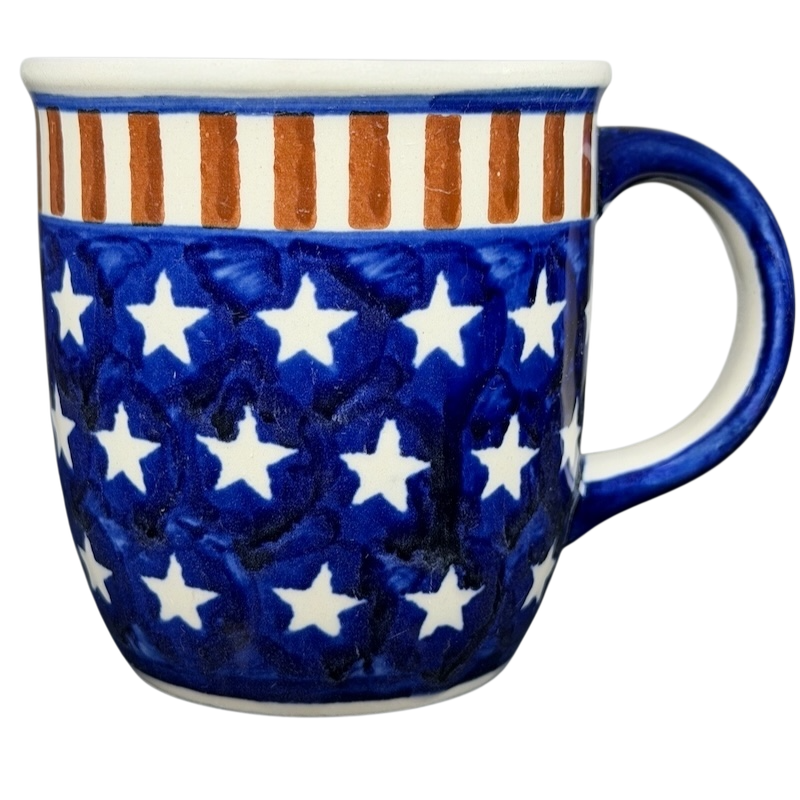 Polish pottery stars and stripes mug featuring a blue design with white stars and orange stripes
