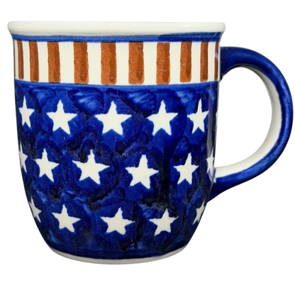 Polish pottery stars and stripes mug featuring a blue design with white stars and orange stripes