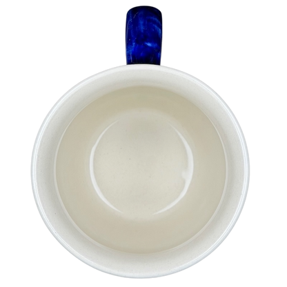 Inside view of Polish pottery stars and stripes mug featuring a smooth interior and blue handle