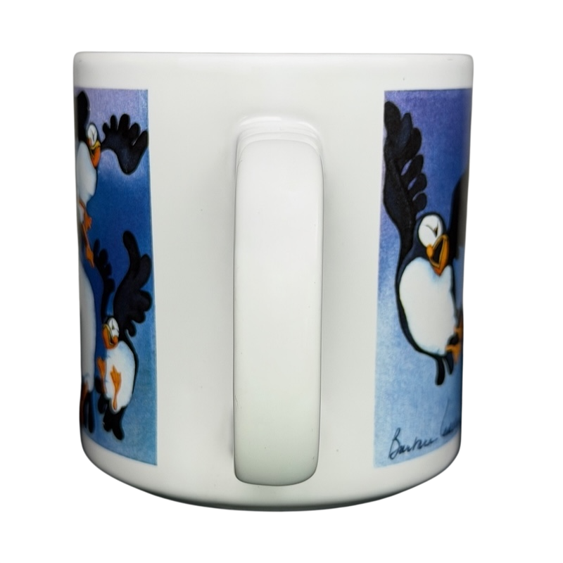 Puffins Barbara Lavallee Mug Arctic Circle Enterprises featuring playful puffin illustrations on a white background