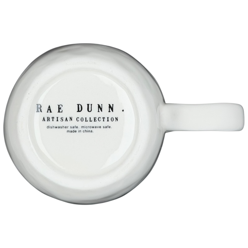 Bottom view of Rae Dunn birdcage mug showing artisan collection details and care instructions