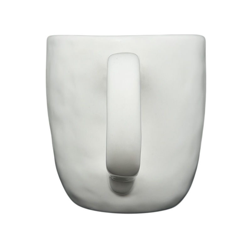 Top view of a Rae Dunn birdcage mug with a smooth white finish and a sturdy handle