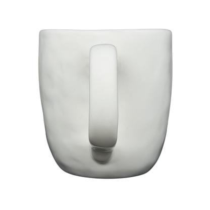 Top view of a Rae Dunn birdcage mug with a smooth white finish and a sturdy handle