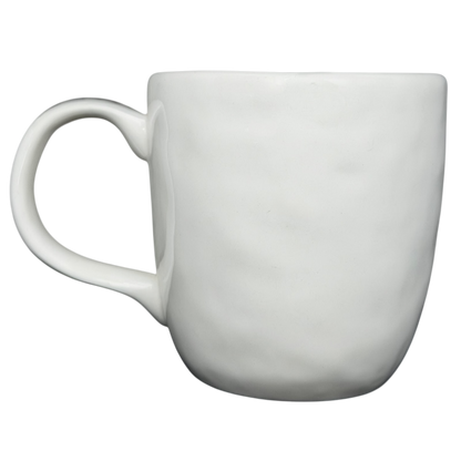 Rae Dunn birdcage mug in white ceramic with textured design and comfortable handle