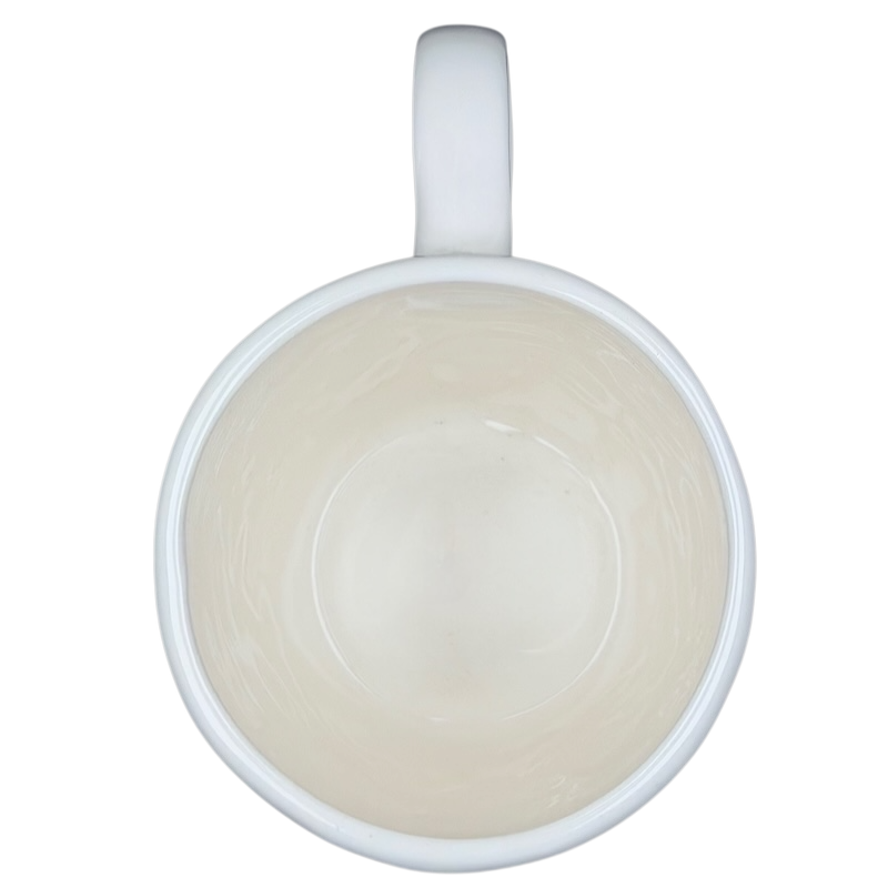 Inside view of a Rae Dunn birdcage mug with a smooth white finish