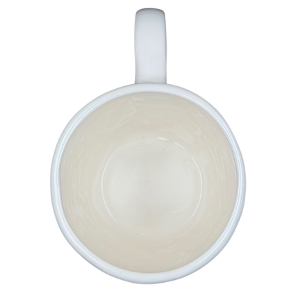 Inside view of a Rae Dunn birdcage mug with a smooth white finish