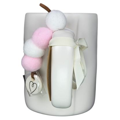 Rae Dunn MAMA Mug Magenta with pastel pom pom decoration and a ribbon bow for stylish beverage enjoyment