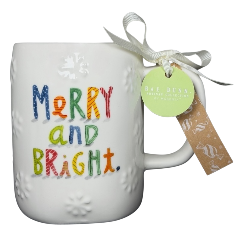 Rae Dunn Merry and Bright collectible mug with colorful lettering and decorative bow