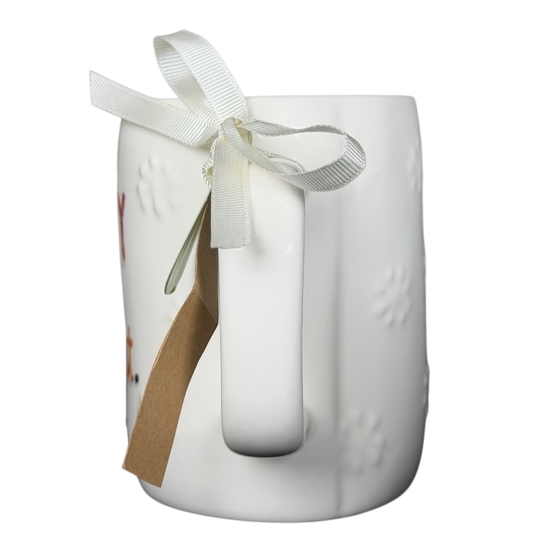 Rae Dunn Merry and Bright collectible mug with embossed design and decorative ribbon detail