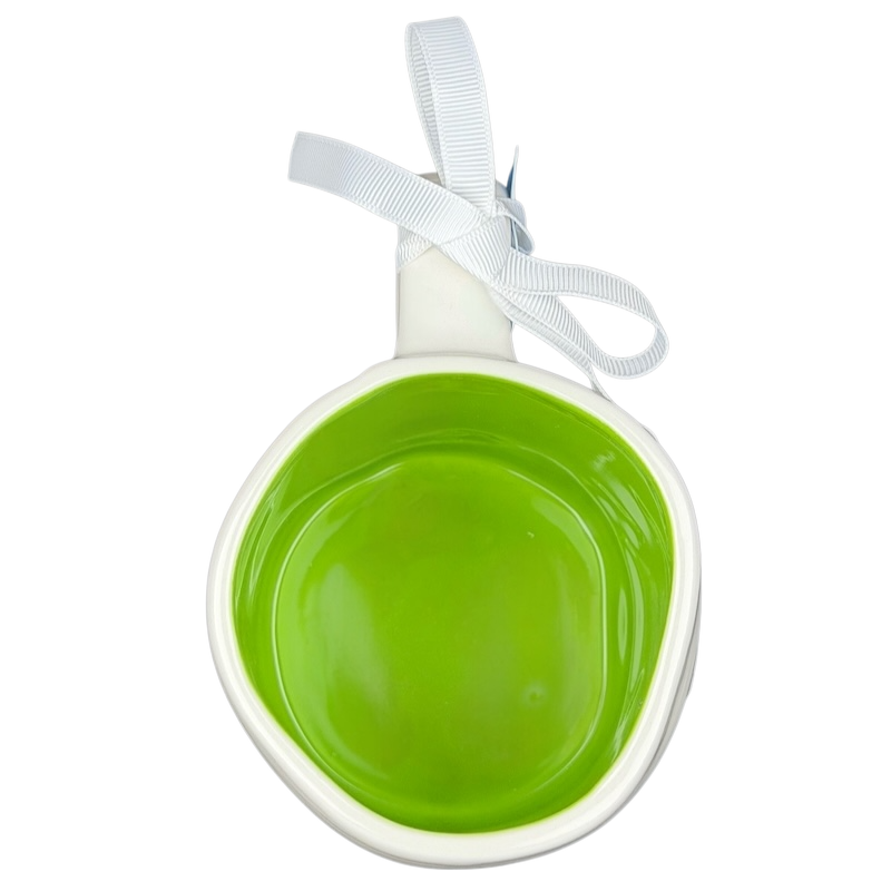 Rae Dunn Toy Story Alien Pixar Disney mug with a bright green interior and a decorative ribbon