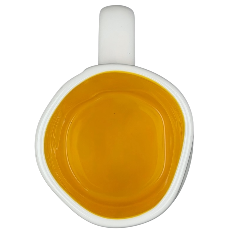 Top view of Rae Dunn Toy Story Woody Pixar Disney mug with vibrant yellow interior and white exterior