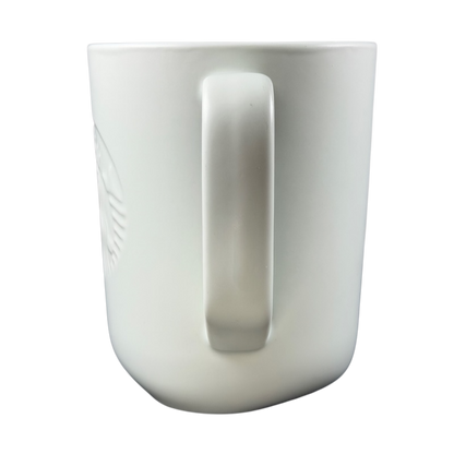 Side view of a recycled ceramic Starbucks mug with a smooth white finish