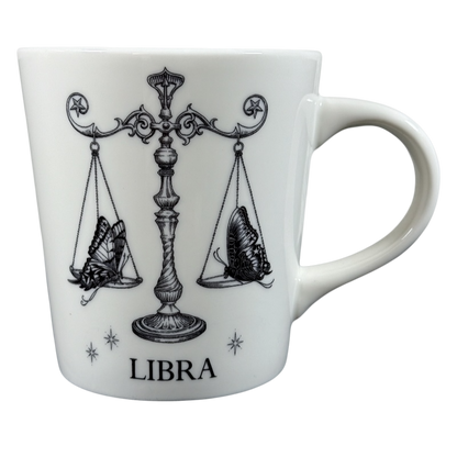 White ceramic Rory Dobner astrology mug featuring Libra zodiac symbol with butterfly scales design