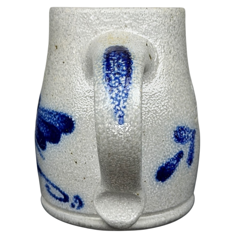 Rowe Pottery Works blue bird mug with intricate blue patterns on a textured white ceramic surface