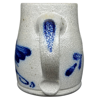 Rowe Pottery Works blue bird mug with intricate blue patterns on a textured white ceramic surface